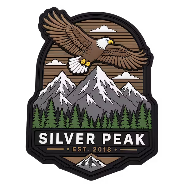 3D PVC patch featuring eagle mountain landscape and forest scene with layered molded rubber details for outdoor branding use
