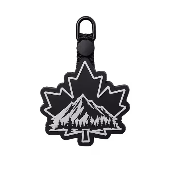 Black and white maple leaf shaped PVC patch attached to a top button loop backing strap